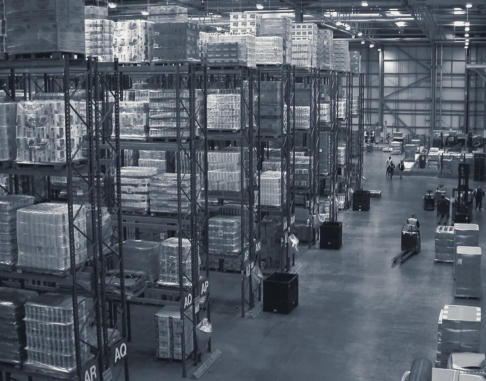 Pallet racking and forklifts inside a distribution centre